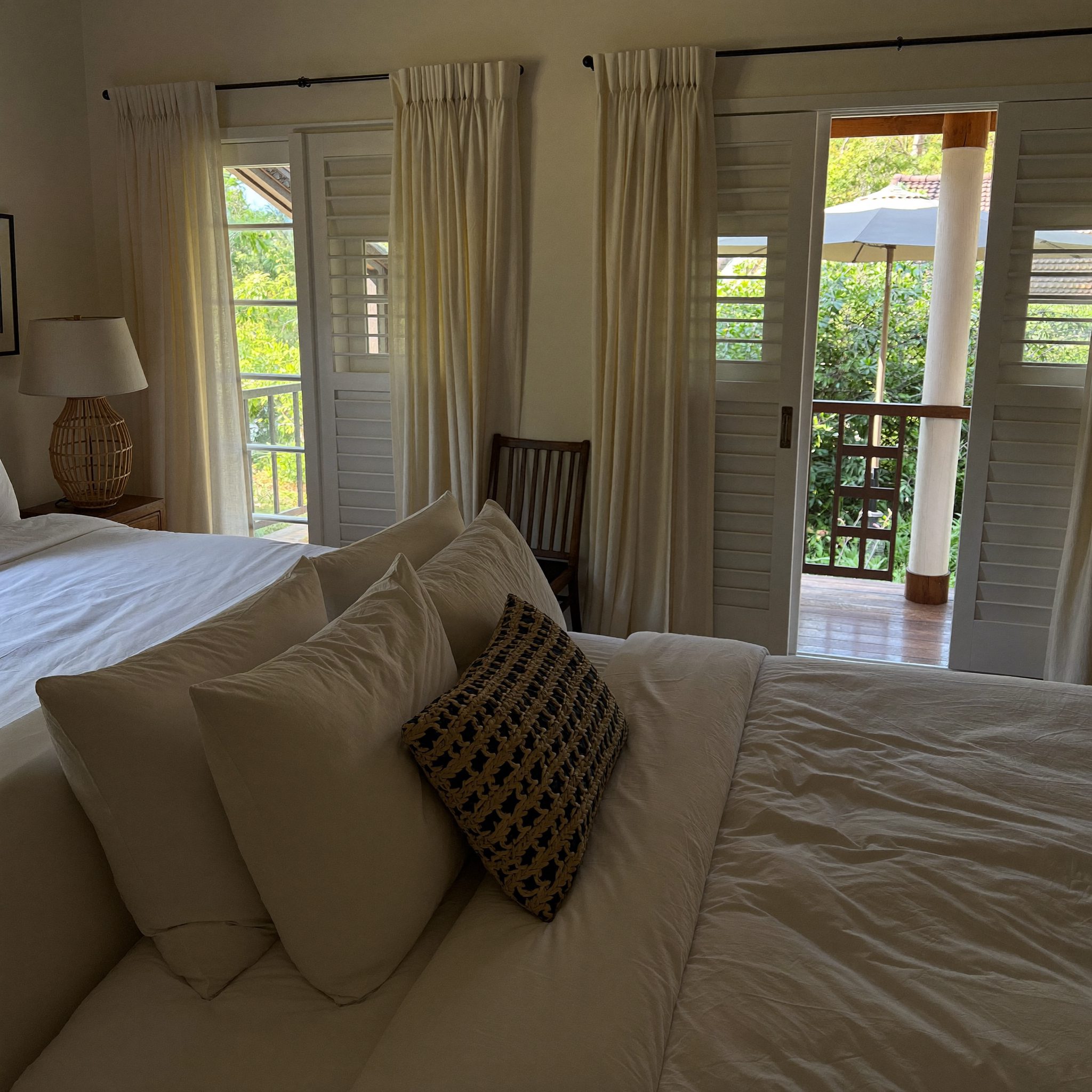 Kamar anak dengan jendela besar dan seprai batik di pagi hari